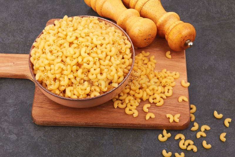Elbow macaroni in bowl stock photo. Image of group, pasta 269888264