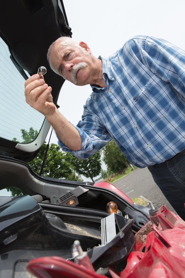 Elder Man Servicing Car at Home Stock Photo Image of pensive