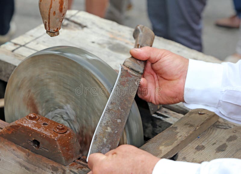 Elder while Sharpening the Blade of the Knife on the Water Wheel Stock