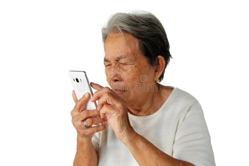 Elderly asian woman are holding and looking mobile phone with poor eyesight isolated on white background