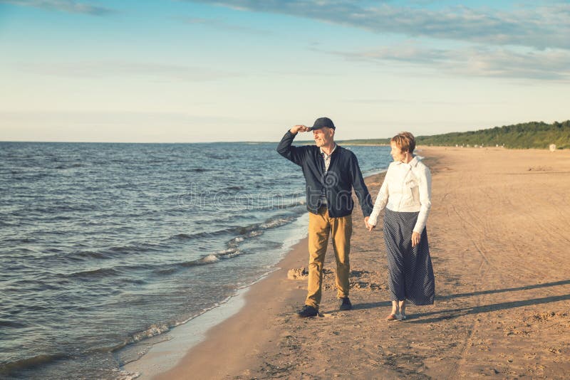elderly couple having romantic walk on the beach stock photography elderly couple having romantic walk on the beach stock photography