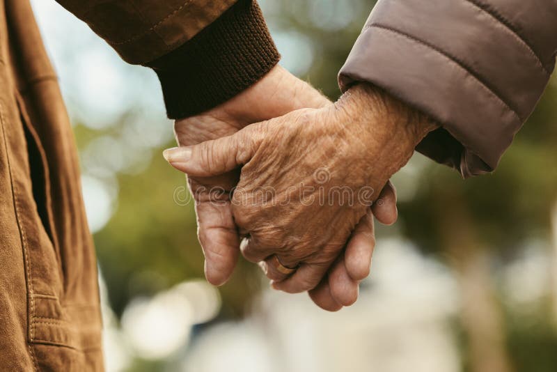 Elderly couple holding hands and walking royalty free stock photos Elderly couple holding hands and walking royalty free stock photos