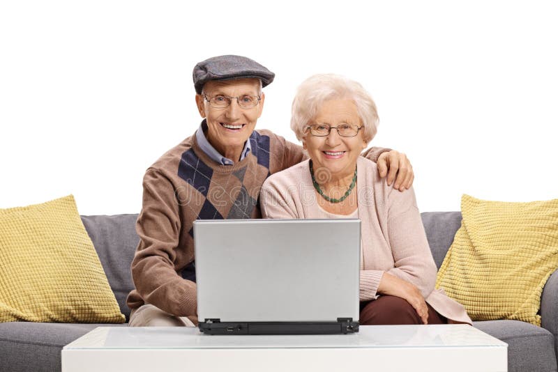 Elderly couple with a laptop sitting on a sofa stock photo Elderly couple with a laptop sitting on a sofa stock photo
