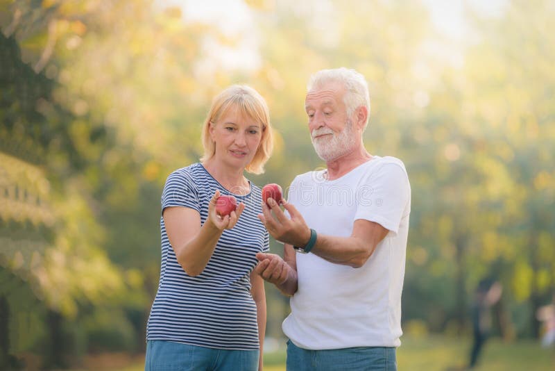 Elderly couple relaxing in garden at sunset. Concept couple elder love royalty free stock photo Elderly couple relaxing in garden at sunset. Concept couple elder love royalty free stock photo