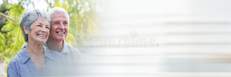 Elderly couple smiling outside and blurry white transition stock photos Elderly couple smiling outside and blurry white transition stock photos