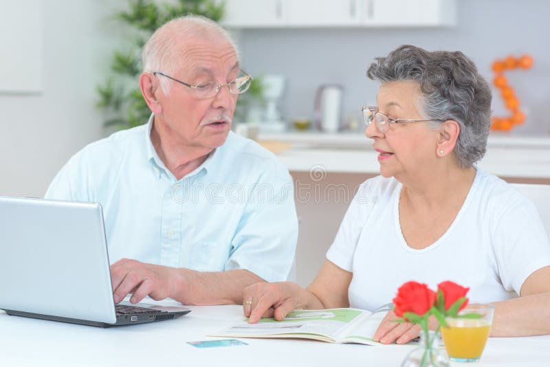 Elderly Couple Using Computer Stock Image - Image of female, laptop