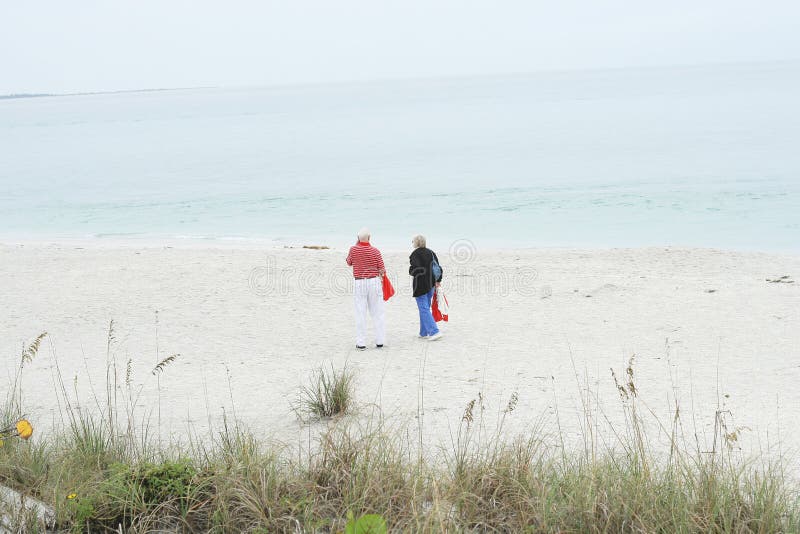 Elderly couple walking on the beach