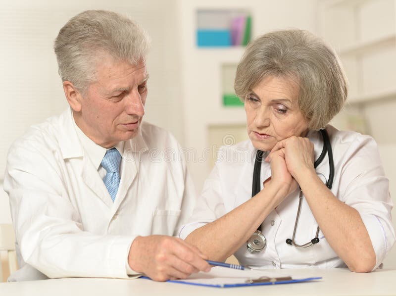 Elderly doctors at table