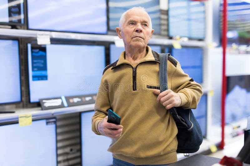 elderly grayhaired man pensioner examining counter with electronic