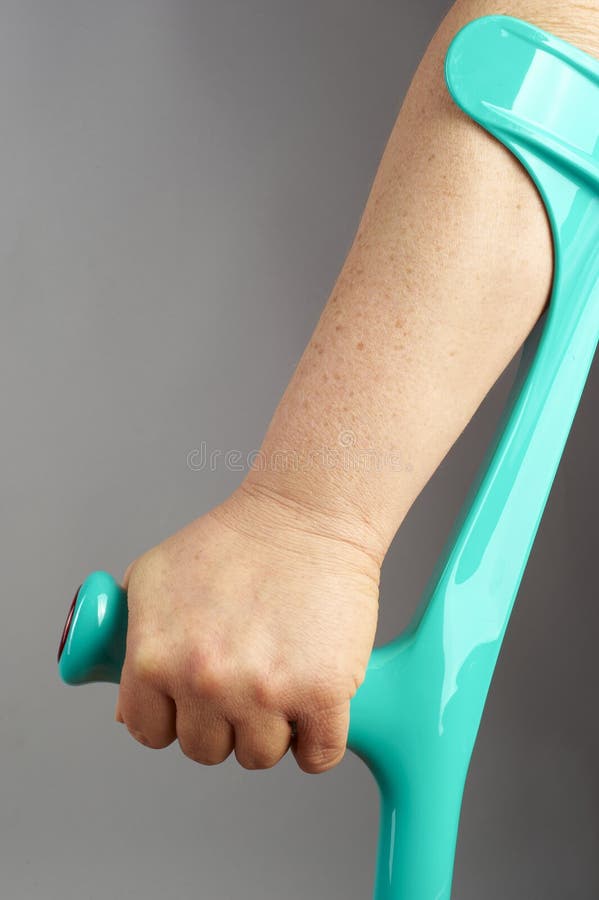 Elderly hand on crutch stock photo. Image of axillary 17309510
