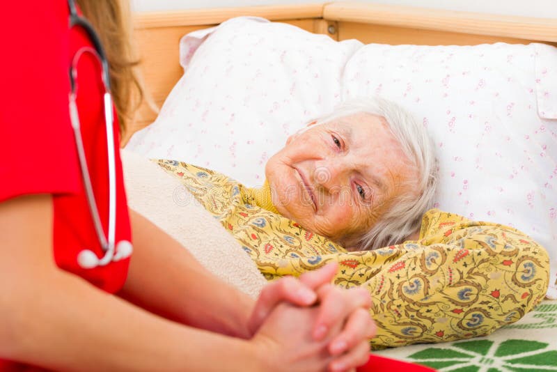 Elderly home care. Photo of elderly woman with the caregiver royalty free stock photo