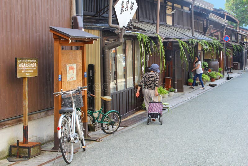 June 2018, Elderly Japanese woman charming street ancient wooden houses, Takayama, Japan