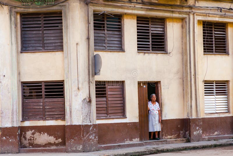 An elderly lady outside a colonial building in old Havana, Cuba. stock images An elderly lady outside a colonial building in old Havana, Cuba. stock images