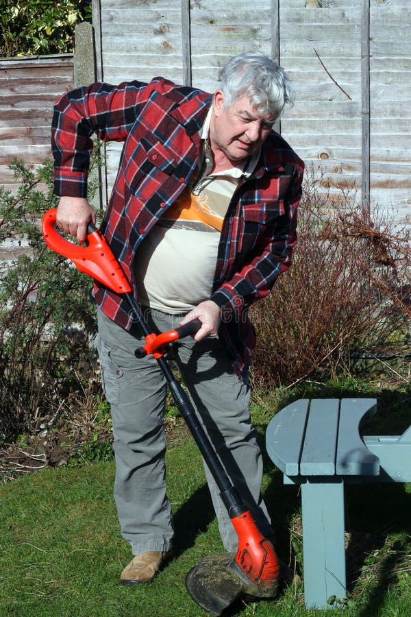 Elderly Male Gardener Trimming Grass Edges. Stock Photo Image of