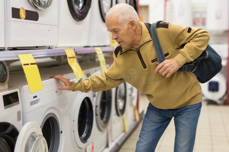 elderly grayhaired man pensioner examining counter with electronic