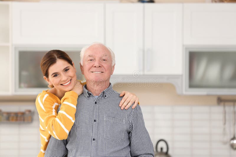 Elderly man with female caregiver in kitchen. royalty free stock images Elderly man with female caregiver in kitchen. royalty free stock images