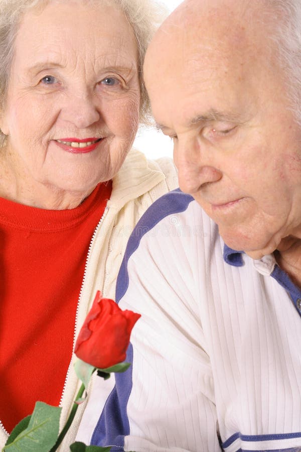Elderly man smelling a rose