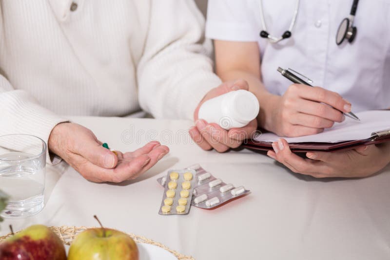 Elderly man taking painkillers stock photo Elderly man taking painkillers stock photo
