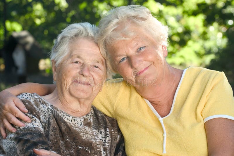 A senior mother sitting by her 60 year old daughter. Old granny stock images, royalty-free photos and pictures