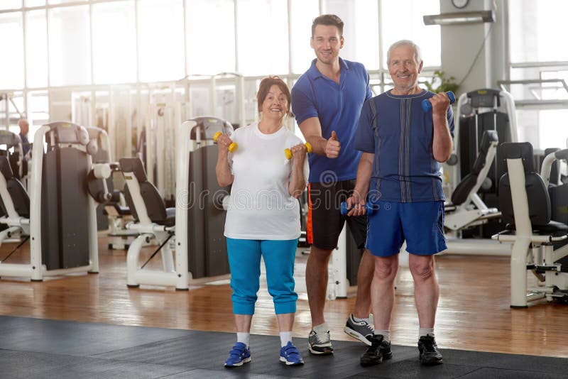 Elderly people with personal trainer at gym. royalty free stock photos Elderly people with personal trainer at gym. royalty free stock photos