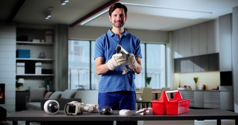 Elderly Technician Smiling While Installing Surveillance Security Camera System. Old cctv monitor stock images, royalty-free photos and pictures
