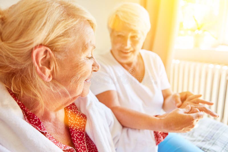 Elderly women gets acupressure treatment on the hand during physiotherapy. Elderly women gets acupressure treatment on the hand during physiotherapy