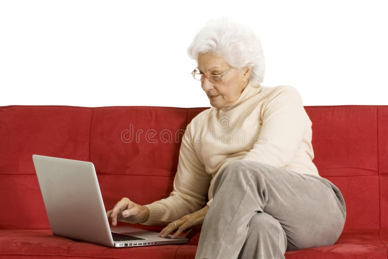 Elderly woman on the couch with laptop