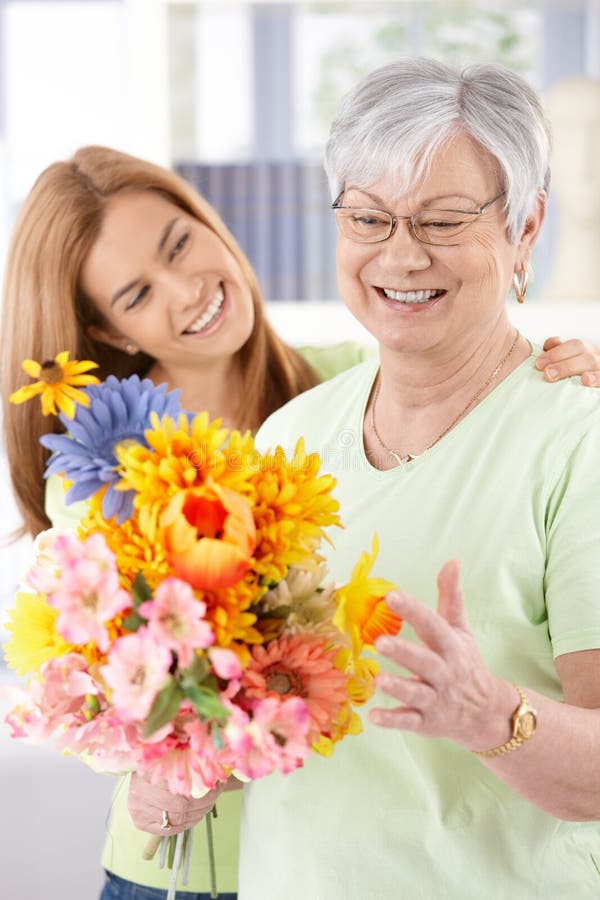 Elderly woman and daughter smiling happily