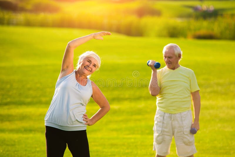 Elderly woman doing exercise. Elderly women doing exercise. Man with dumbbells outdoor. Feeling strong and healthy. Start your day with training stock image