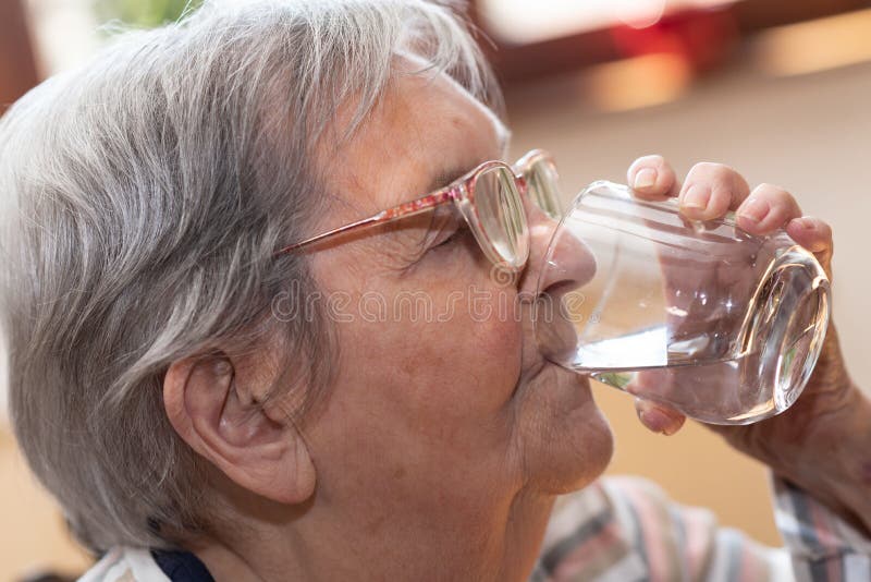 Elderly Woman Drinking Water Stock Image Image of elderly, home 196938911