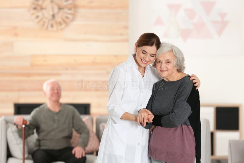 Elderly Woman With Female Caregiver In Living Room Stock Image Image