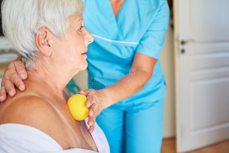 Elderly woman gets a trigger point massage with a small massage ball in the physio. Elderly woman gets a trigger point massage with a small massage ball in the physio