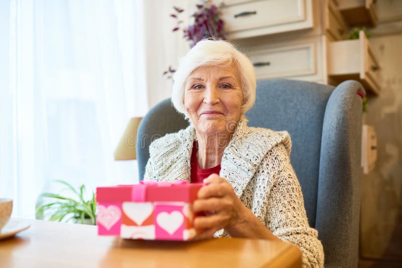 Elderly Woman with Gift Box royalty free stock photo Elderly Woman with Gift Box royalty free stock photo