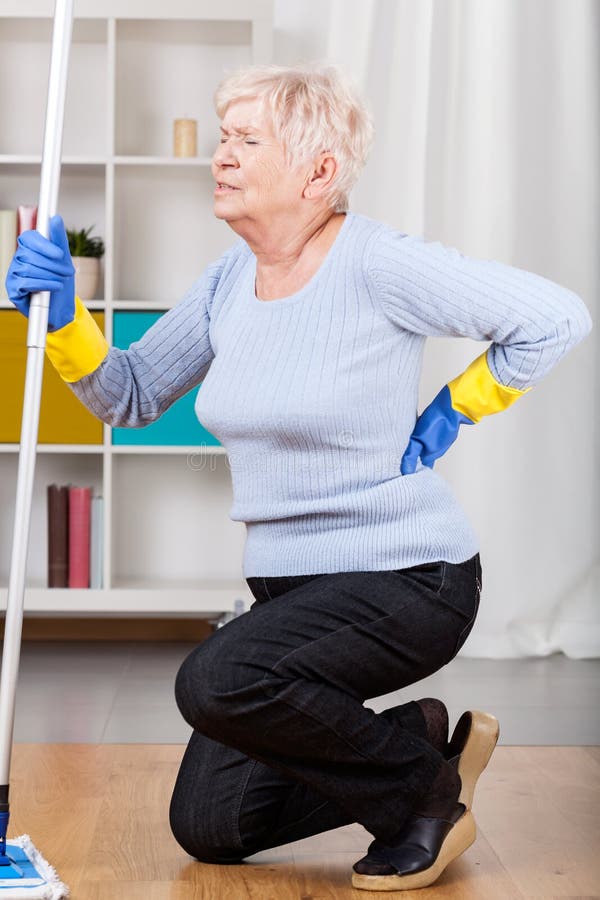 Elderly woman having back pain while cleaning. Problem wrinkle stock images, royalty-free photos and pictures