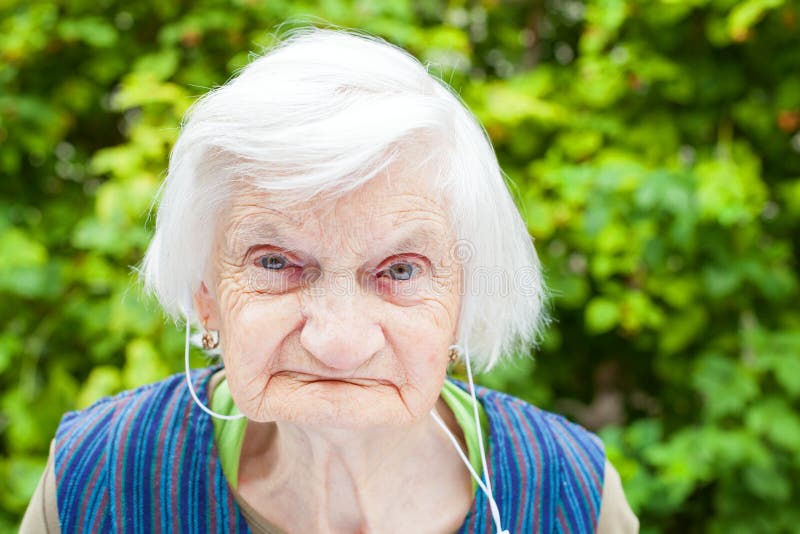 Elderly woman listening to music with headphones stock images Elderly woman listening to music with headphones stock images