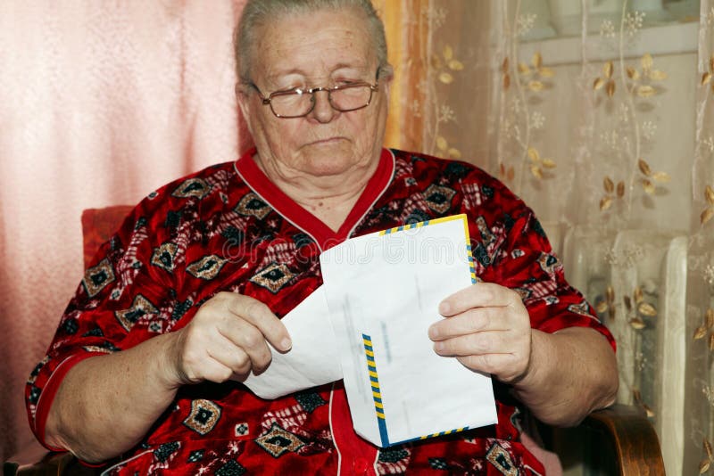 Elderly woman and open letter royalty free stock images Elderly woman and open letter royalty free stock images
