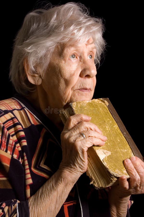 Elderly woman reads the book