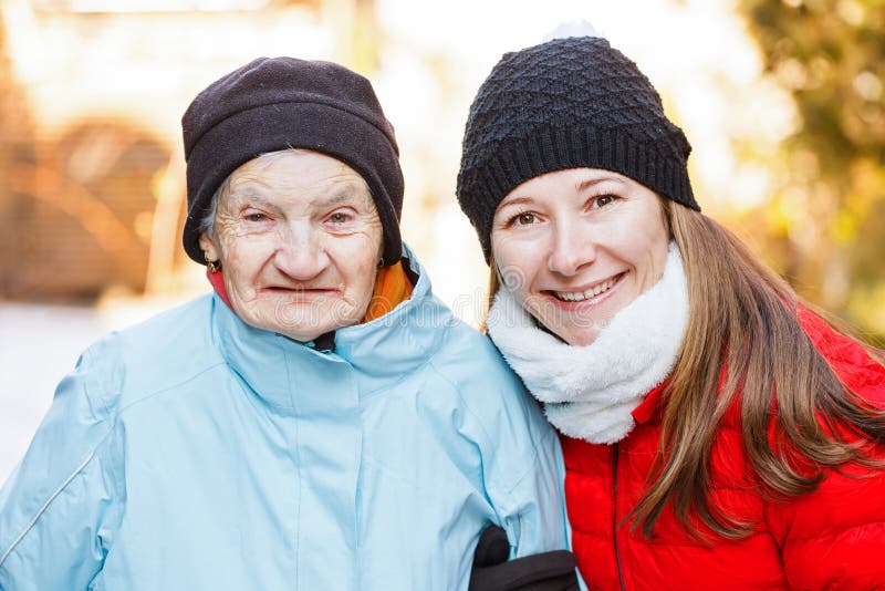 Elderly woman and young carer. Photo of elderly women with her caregiver royalty free stock photos