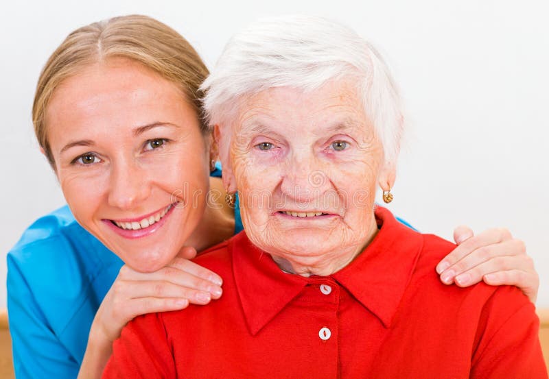 Photo of elderly women supported by young doctor. Photo of elderly women supported by young doctor