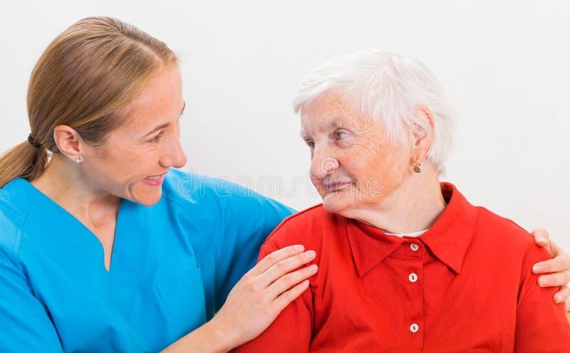 Photo of elderly women supported by young doctor. Photo of elderly women supported by young doctor