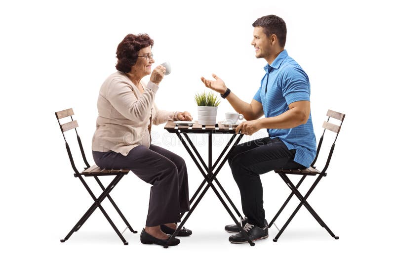 Man chat. Пожилые и молодые люди пьющие кофе. Взрослый и молодой беседуют. Woman and man sit on the Table.