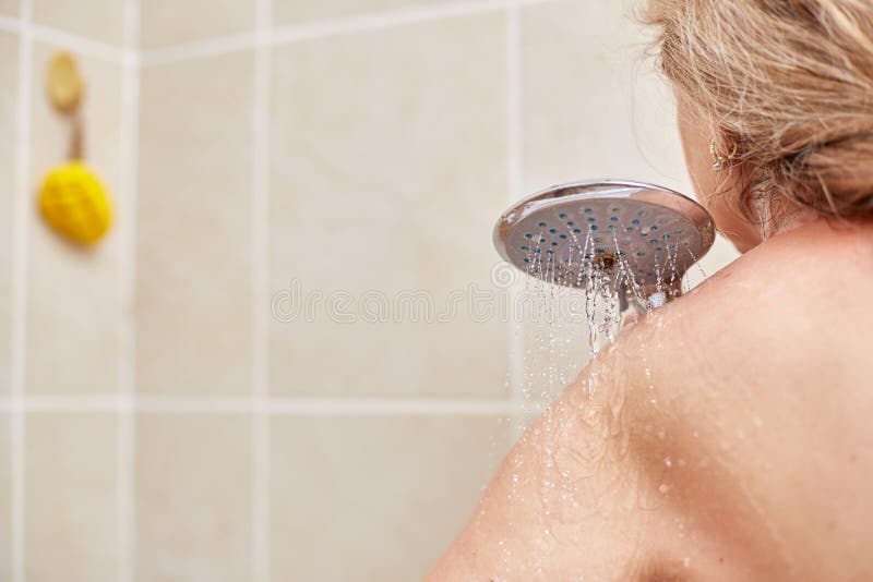 Mature woman recording herself having fun while showering