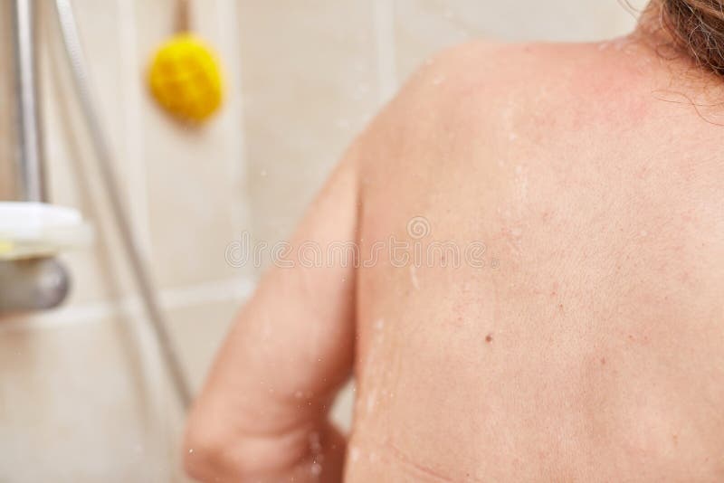 Mature woman recording herself having fun while showering