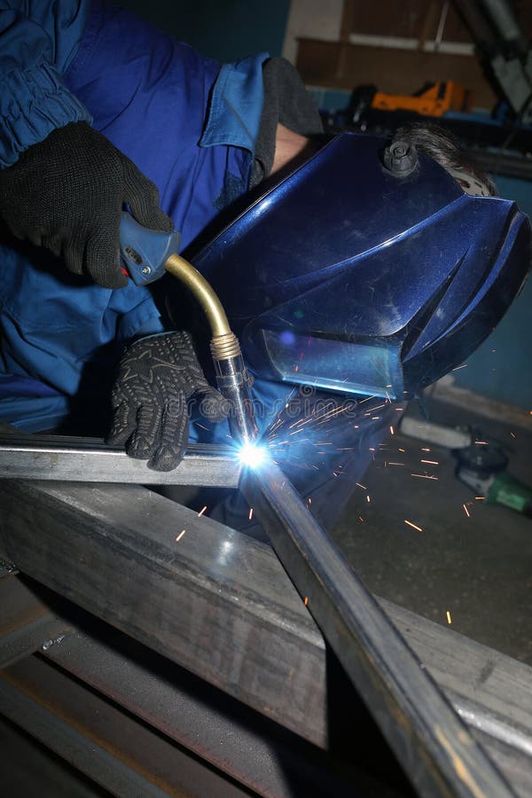 Electric Arc Welding. the Worker Welding Two Iron Corners Stock Image