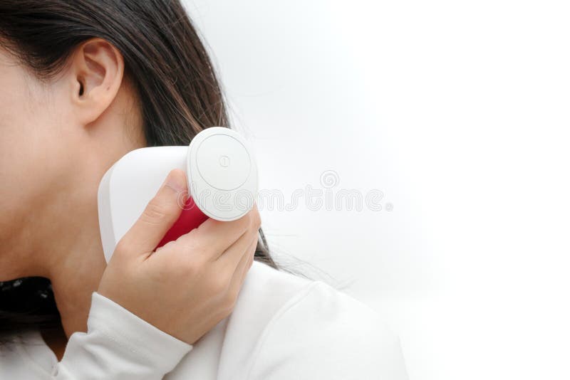 Electric arm, neck and shoulder massage machine on women shoulder, closeup, healthcare and medicine concept royalty free stock image Electric arm, neck and shoulder massage machine on women shoulder, closeup, healthcare and medicine concept royalty free stock image
