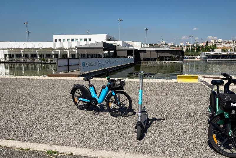 Electric Bikes and Escooters Parked on the Pier in Lisbon Editorial