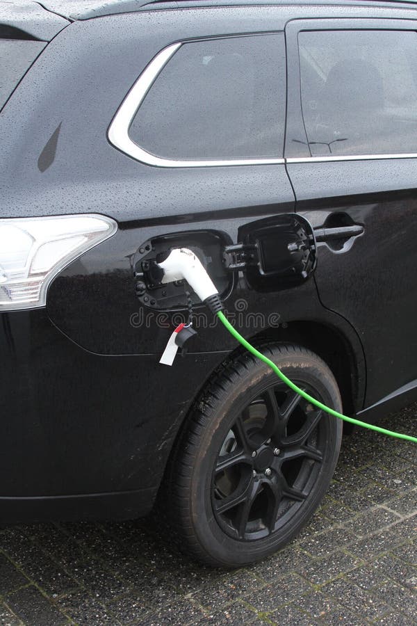 Modern electric plug car charges new electric energy, Netherlands royalty free stock photography Modern electric plug car charges new electric energy, Netherlands royalty free stock photography