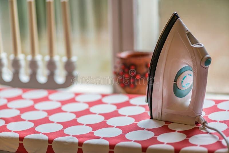 Electric Clothes Iron on the Ironing Board Stock Image Image of
