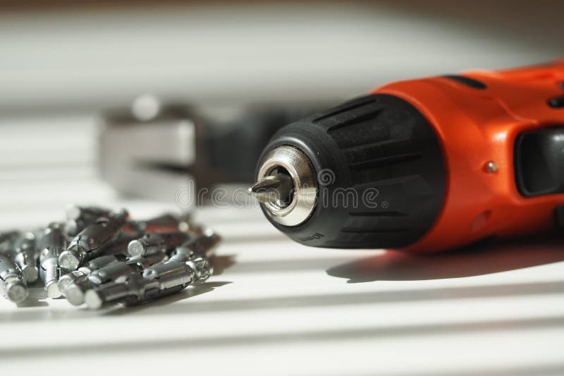 Electric drill and screwdriver bits on a workbench royalty free stock image