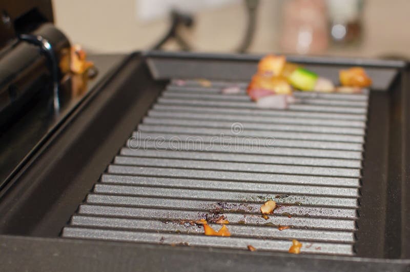 Electric Grill after Roasting Meat. Oily Greasy Surface of the Electric Grill Stock Photo